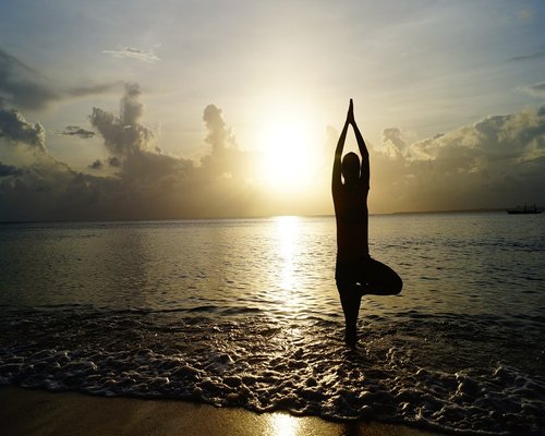 Person doing gentle yoga pose outdoors